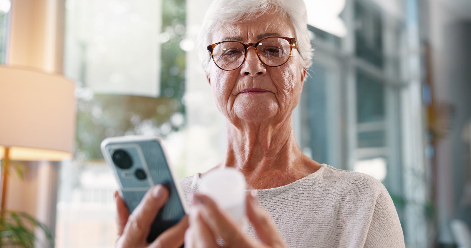 A patient reviewing a medication with a phone in hand